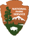 A national park service logo with trees and mountains in the background.